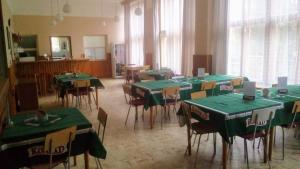 a room with tables and chairs with green table cloth at Penzion Koniklec in Jestrabi V Krkonosich +2 photos