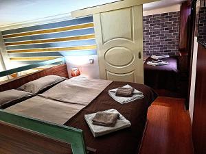 a bedroom with a bed with two towels on it at Apartment Cabin-Style in Belgrade