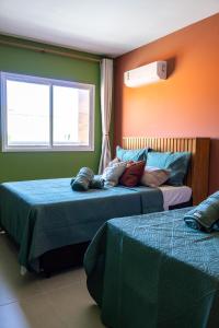 En eller flere senge i et værelse på Apartamento em Cabo Frio Proximo a Praia do Forte + 45 billeder