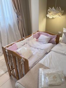 a crib bed with white and pink pillows in a room at Queen Nefertari-Luxury Apartment Near Pyramids Giza in Cairo