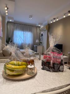 a table with bananas and other groceries on it at Queen Nefertari-Luxury Apartment Near Pyramids Giza in Cairo