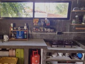 a kitchen with a counter with a stove and a window at SUMMER STAY A Starlink in General Luna
