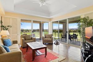 a living room with a couch and a table at Peaceful condo with lanai & beach essentials in Waikoloa +33 photos