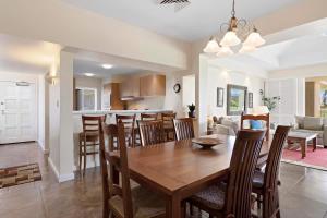 a dining room and living room with a table and chairs at Peaceful condo with lanai & beach essentials in Waikoloa