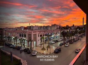 een stadsstraat met auto's geparkeerd op een parkeerplaats bij Marchica bay 8 holiday Apartment in Nador