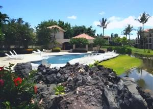 a view of a pool at a resort at Golf-view condo with golf discounts & lanai in Waikoloa