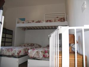 a bedroom with two bunk beds and a staircase at Casa Carla in Cavo