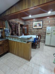 a kitchen with a counter top and a refrigerator at Casa Quijote in Chiautla