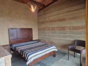 a bedroom with a bed and a chair in it at Casa Solar in São Bento do Sapucaí +17 photos