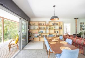 a living room with a table and a couch at Honeybird Hideaway in Crabbes Creek +20 photos
