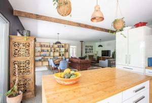 a kitchen with a table with a bowl of fruit on it at Honeybird Hideaway in Crabbes Creek
