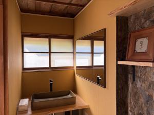 un bagno con lavandino e specchio di Tasogare 