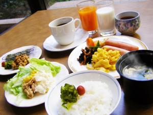 a table with plates of food and cups of coffee at Hotel Furukawa Hills in Osaki