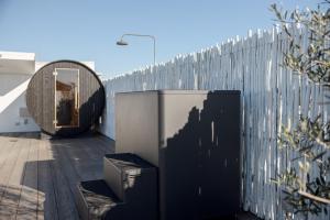 a fence with a trash can in front of a building at Wake Up! Bondi Beach in Sydney