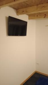 a flat screen tv on the wall of a room at Paraje Sur in Ushuaia