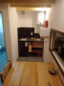 a small kitchen with a wooden table in a room at Paraje Sur in Ushuaia