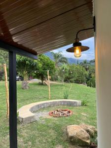a view of a backyard with a fire pit at chalé cilla in Caparaó Velho +10 photos