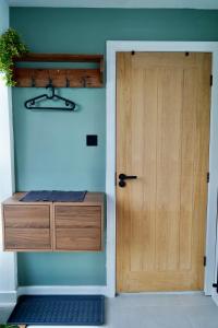 a wooden door in a room with a desk at The Cozy Cave in Castleton