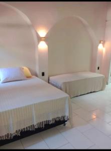 En eller flere senge i et værelse på Casa iris