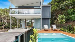 a house with a swimming pool in front of it at Luxury On The Bay - Wanda in Suffolk Park