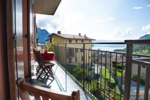 a balcony with a view of a lake and a house at La Casa di Emy in Solto Collina