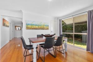 a dining room with a table and chairs at Rainbow Tides - Rainbow Beach in Rainbow Beach +11 photos