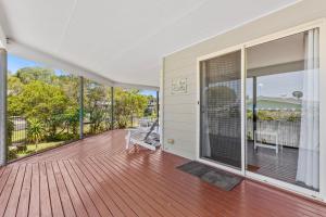 an empty house with a deck with a bench at Rainbow Tides - Rainbow Beach in Rainbow Beach