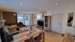 un soggiorno con un divano e un tavolo di Ferienhaus Plattfisch a Dornum