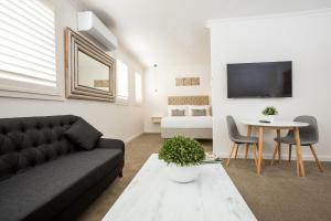 a living room with a couch and a table at Newington Apartments in Ballarat