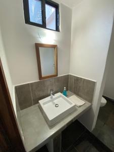 een badkamer met een witte wastafel en een spiegel bij Costa Ayala - Bungalow 6 with 2dbl beds, 2 sofas in Los Ayala +12 foto's