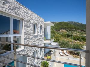a balcony with a view of a house at Villa in Bol with swimming pool in Bol