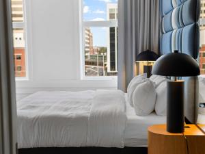 a bedroom with a white bed and a window at Symons Block Suite 7 in Spokane