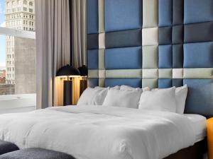 a bedroom with a large bed with a blue wall at Symons Block Suite 7 in Spokane