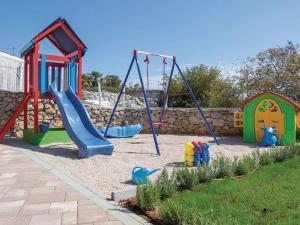 a playground with a slide and swings at Villa in Korni with swimming pool in Kornić