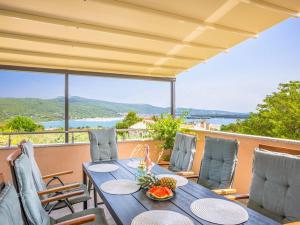 a table and chairs on a balcony with a view at Villa in Korni with swimming pool in Kornić