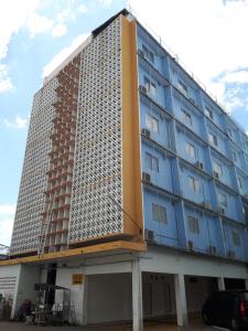 a tall building with a lot of windows at Anodard Hotel in Nakhon Sawan