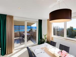 a dining room with a table and a large window at Villa in Korni with swimming pool in Kornić