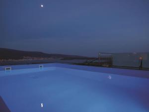 a swimming pool at night with a view of the city at Villa in Korni with swimming pool in Kornić