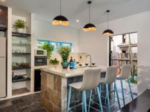 a kitchen with a island with chairs and a counter top at Emerald Coast House in An Bàn (2)