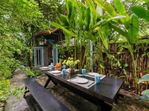 a wooden table with plates of food on it at Emerald Coast House in An Bàn (2)