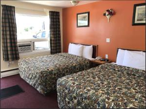 a hotel room with two beds and a window at River Mist INN in Sturgeon Falls