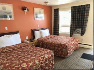a hotel room with two beds and a window at River Mist INN in Sturgeon Falls