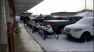 a group of motorcycles parked in a snow covered parking lot at River Mist INN in Sturgeon Falls