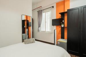 a bedroom with a white bed and a window at Elva Shine Dalat Hotel in Da Lat