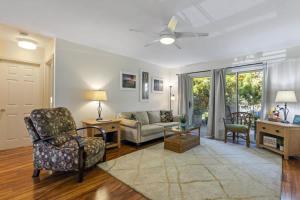 a living room with a couch and a chair at Waikoloa retreat with BBQ & pool access in Waikoloa Village