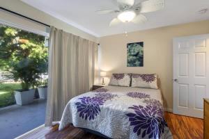 a bedroom with a bed and a large window at Waikoloa retreat with BBQ & pool access in Waikoloa Village