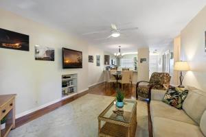 a living room with a couch and a table at Waikoloa retreat with BBQ & pool access in Waikoloa Village +20 photos