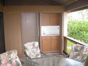 an outdoor patio with a table and two chairs at Peaceful golf retreat with shared pools in Waikoloa Village +15 photos