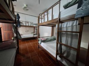 a room with two bunk beds and a room with a hallway at Bami hostel in Thakhek