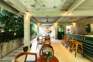 a restaurant with a row of tables and chairs at Shelter Island in Ubud